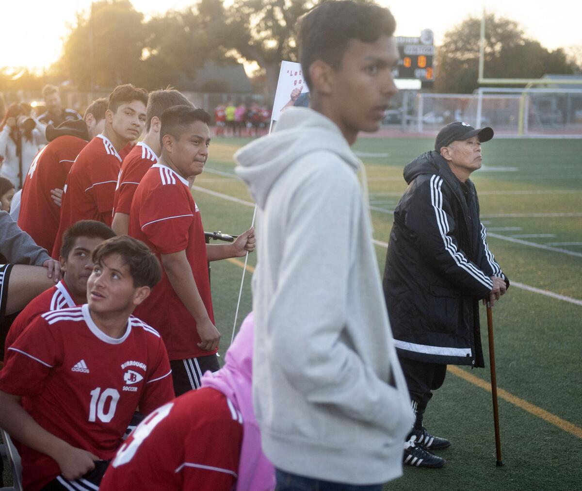 Former Burroughs High boys soccer coach Mike Kodama, far right, watches the action of Thursday's game against Burbank. (Photo by Miguel Vasconcellos)