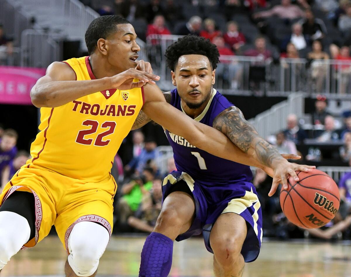 USC guard De'Anthony Melton tries to steal the ball from Washington guard David Crisp during the first half of a Pac-12 Conference tournament game last season.