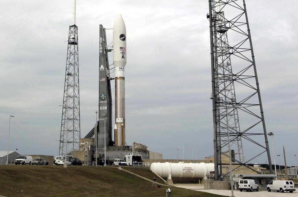 A United Launch Alliance Atlas V rocket stands ready for launch at the Cape Canaveral Air Force Station in 2012. The Atlas V is propelled by a Russian-made engine.