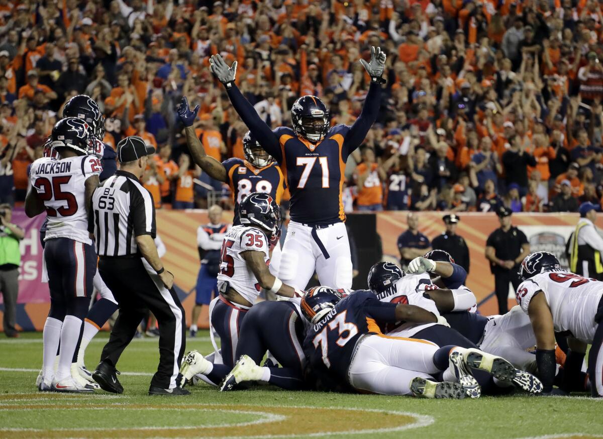 Broncos offensive tackle Donald Stephenson (71) celebrates a touchdown run by teammate Andy Janovich against the Houston Texans during the second half on Oct. 24.