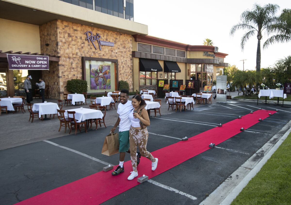 A couple leaves Fleming's Prime Steakhouse after dining outdoors in Woodland Hills on July 17.