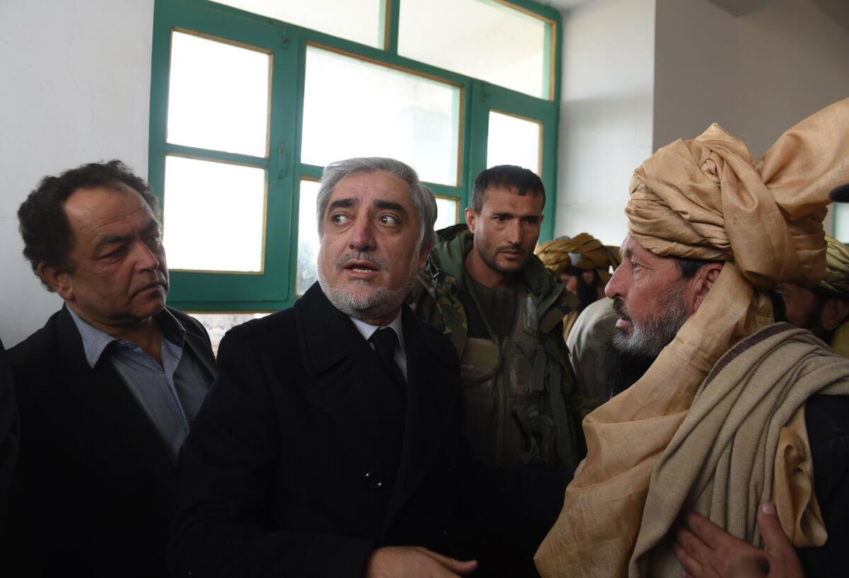 Afghanistan's chief executive, Abdullah Abdullah, second from left, speaks during an official visit to the Yahya Khail district in Paktika province in November 2014 following a previous suicide attack at a volleyball game.