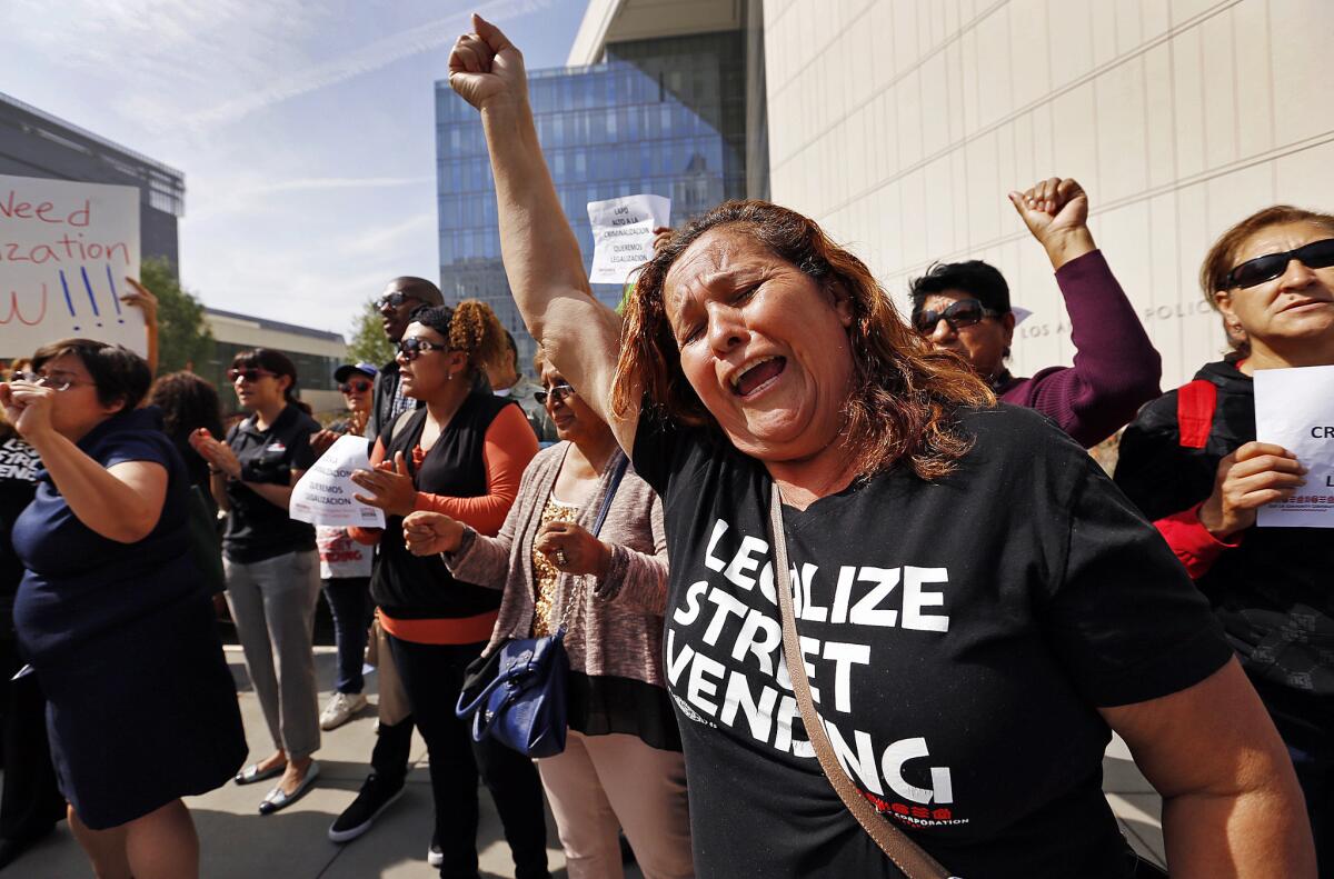 Caridad Vasquez joins other vendors and their supporters in a protest outside Los Angeles police headquarters.