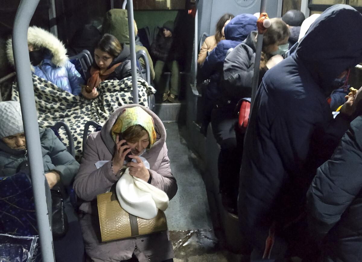 People sit inside a bus.