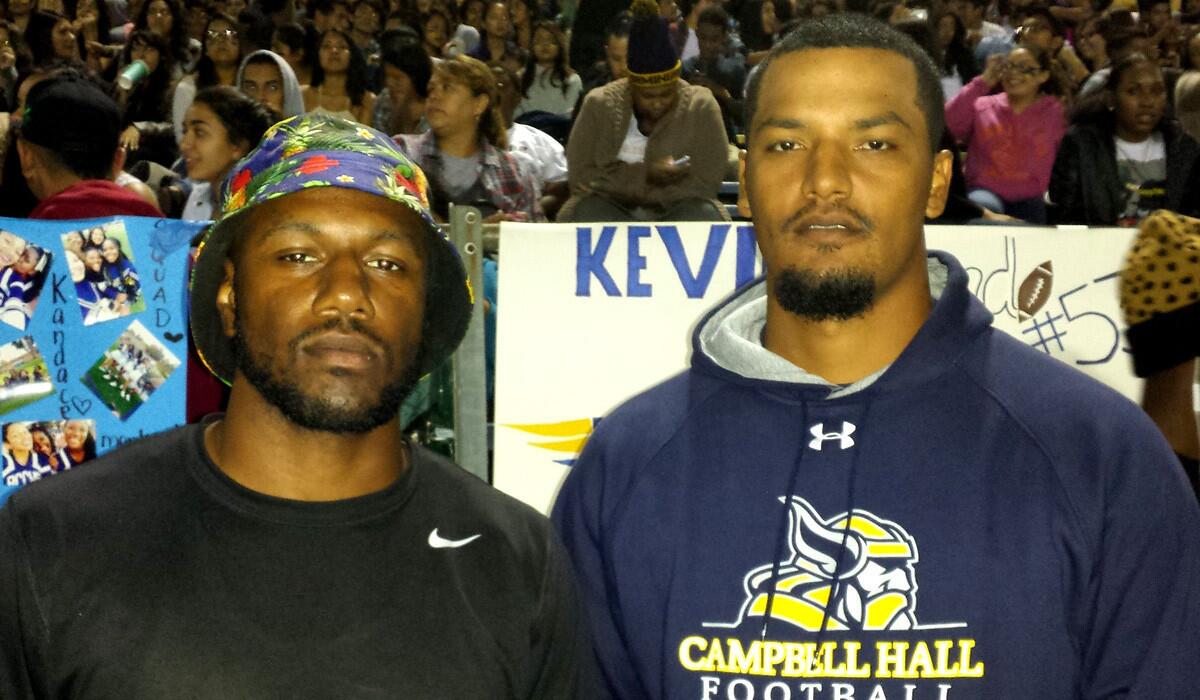 Former Birmingham stars Milton Knox, left, and Dennis Keyes along the sideline at the Patriots' victory over Taft on Friday night.