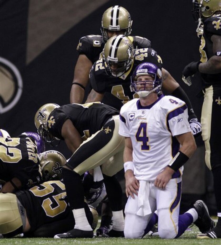 FILE - This Jan. 24, 2010, file photo shows Minnesota Vikings quarterback Brett Favre (4) reacting after fumbling the ball, which was recovered by the New Orleans Saints during the second quarter of the NFC Championship NFL football game in New Orleans. The Vikings were left to stew over their loss until this Thursday night, when the NFL's season kicks off with a rematch of one of the most riveting games played last season. (AP Photo/Mark Humphrey, File)