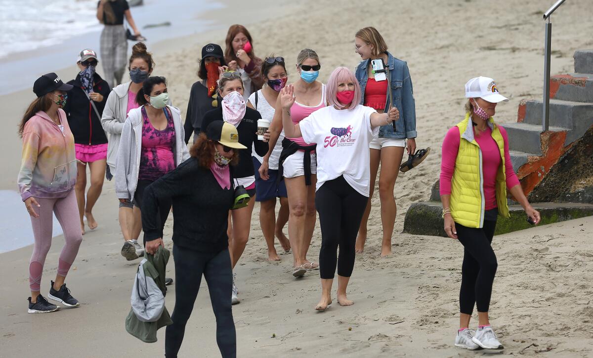 Sharael Kolberg of Laguna Beach walks past Brooks St. with her team during her "50 for the Cure" walk for her 50th birthday. 