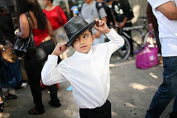 Eight-year-old Andrew Ocampo of Los Angeles does a Michael Jackson imitation near Staples Center prior to a memorial for the late pop star.