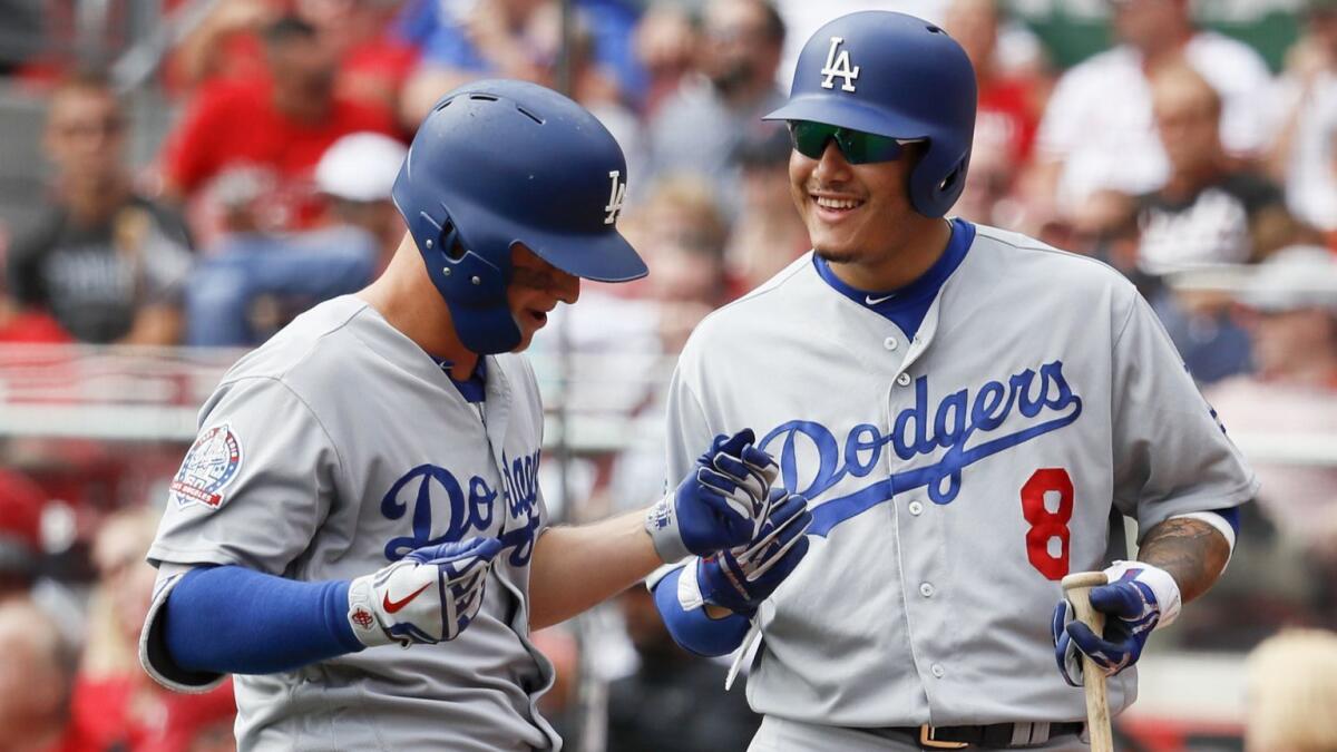 Joc Pederson, left, celebrates with Manny Machado after hitting a solo home run off Cincinnati starter Anthony DeSclafani in the fourth inning on Wednesday.