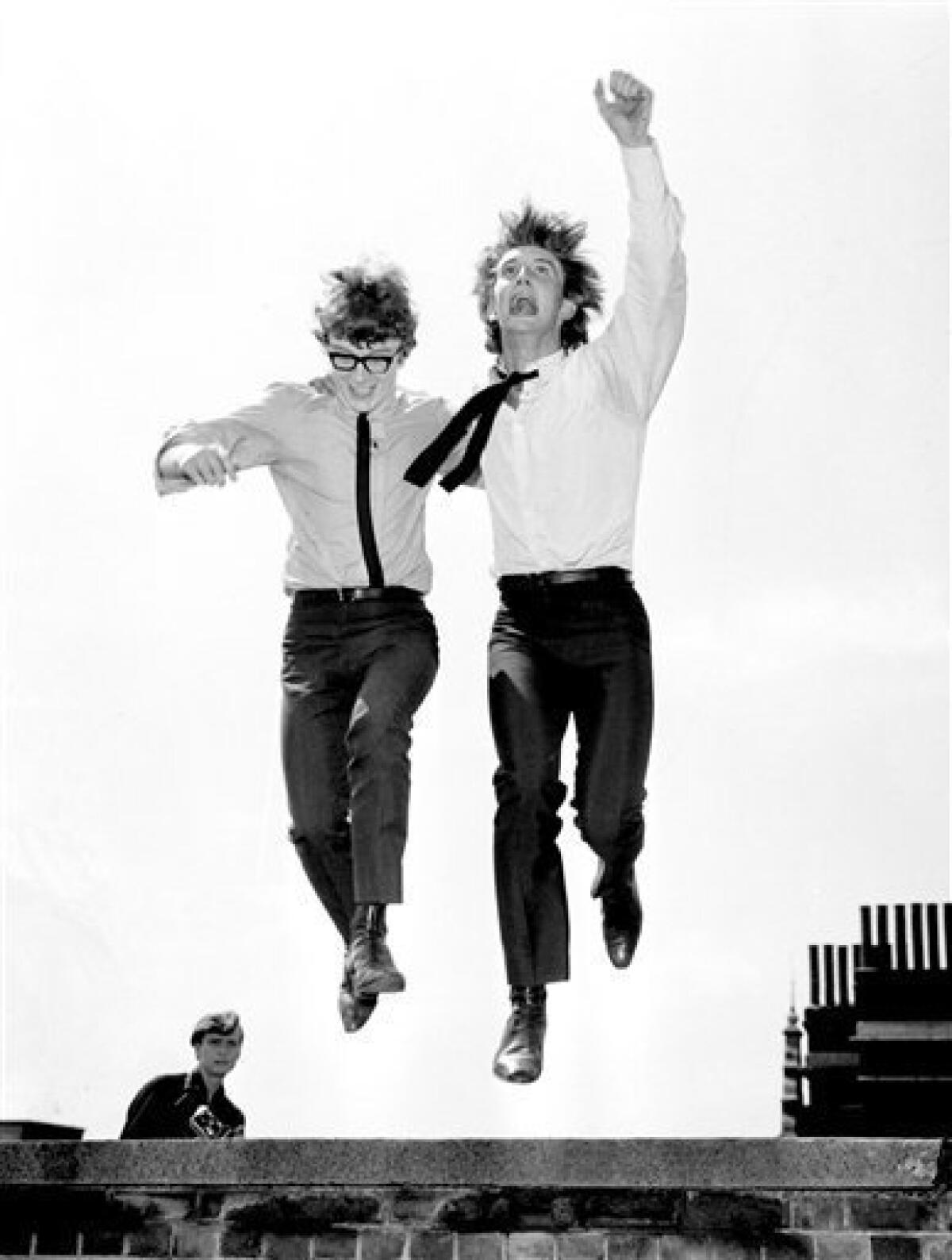 FILE- In this July 28, 1964 file photo, British pop singers Gordon Waller, right, and Peter Asher leap in the air upon their return to London after a successful American tour. Waller, who had a string of hits in the 1960s including several written by Paul McCartney, died Friday, July 17, 2009. He was 64. (AP Photo)