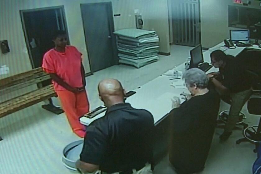 FILE - In this undated file frame from video provided by the Waller County Sheriff's Department, Sandra Bland stands before a desk at Waller County Jail in Hempstead, Texas. A grand jury decided that neither sheriff's officials nor jailers committed a crime in the treatment of Bland, a black woman who died in a Texas county jail last summer, but has not yet determined whether the state trooper who arrested her should face charges, a prosecutor said. (Waller County Sheriff's Department via AP, File)