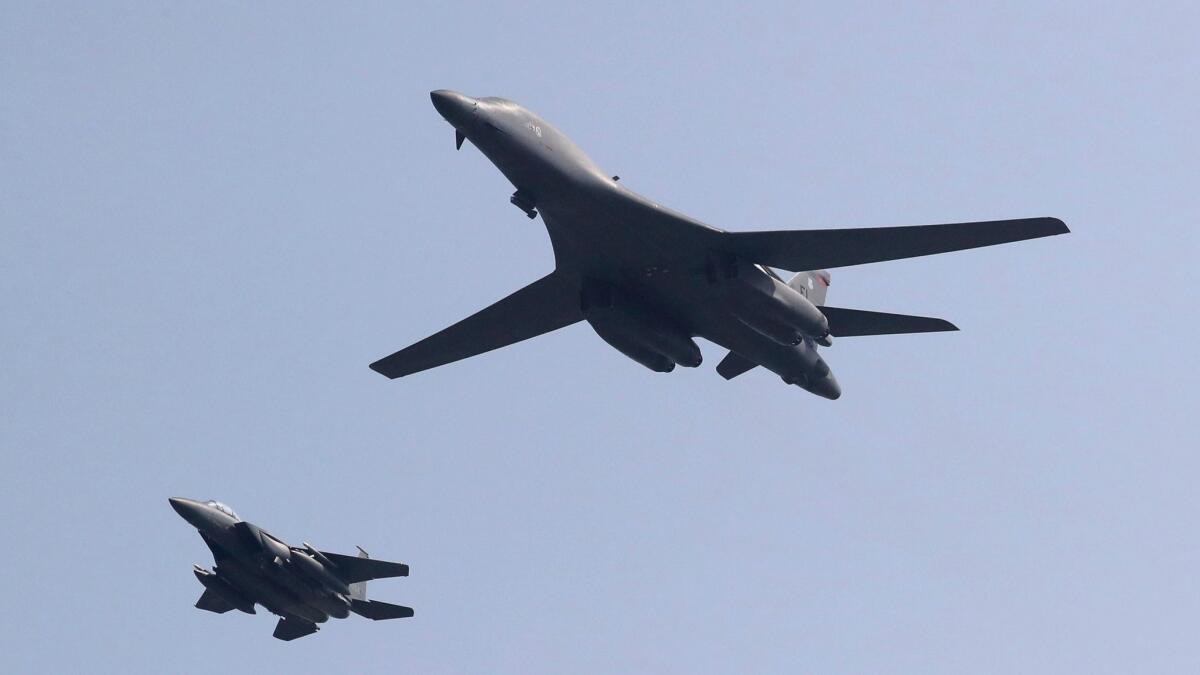 A U.S. B-1B bomber, right, flies over Osan Air Base with a U.S. fighter jet in Pyeongtaek, South Korea. The United States flew two supersonic bombers over the Korean Peninsula on Tuesday, June 20, 2017, in a show of force against North Korea.