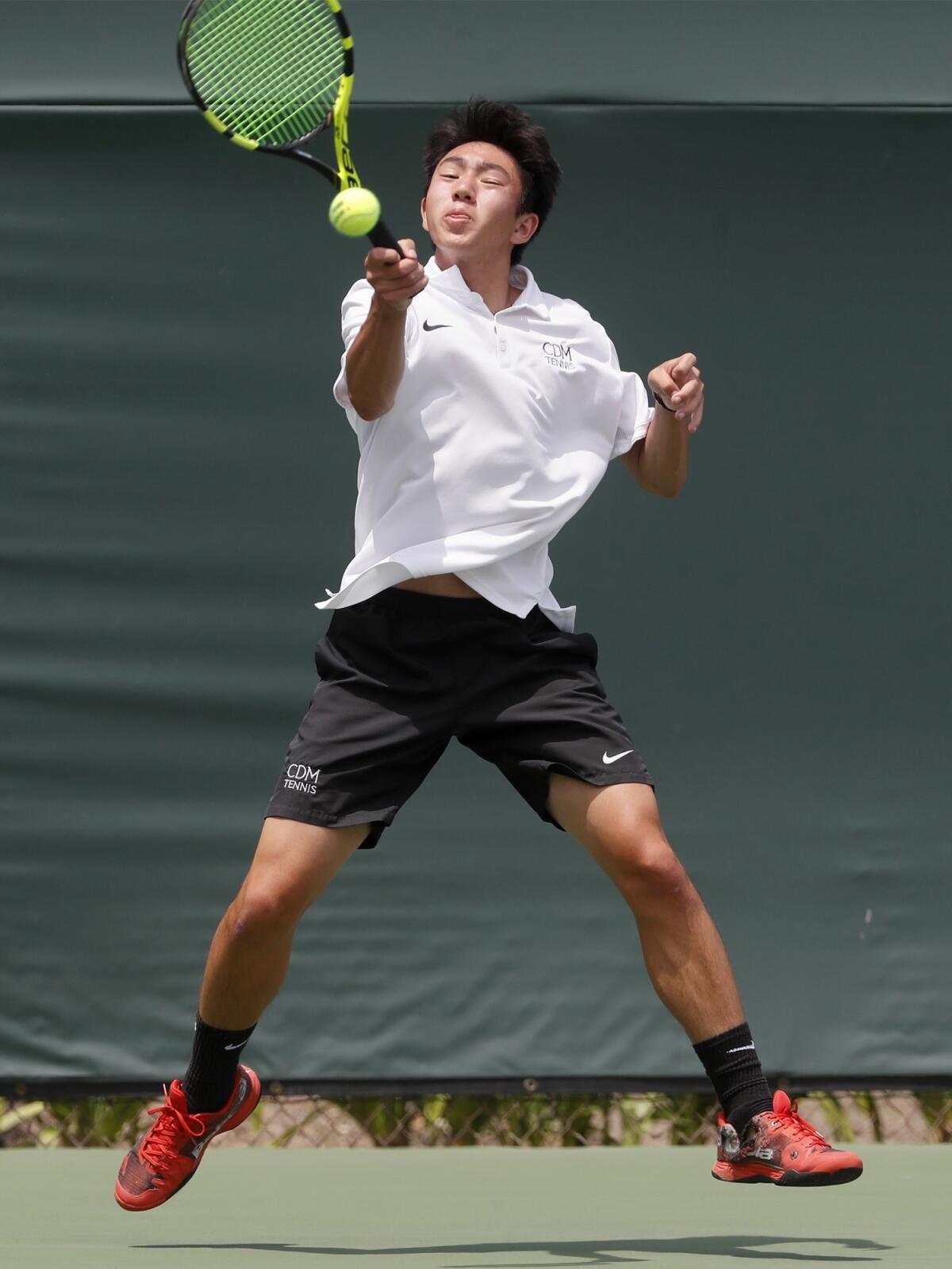 Corona del Mar's Kyle Pham hits the ball against St. Francis' Ian Freer in the singles final of the CIF Southern Section Individuals tournament on Thursday at Seal Beach Tennis Center.