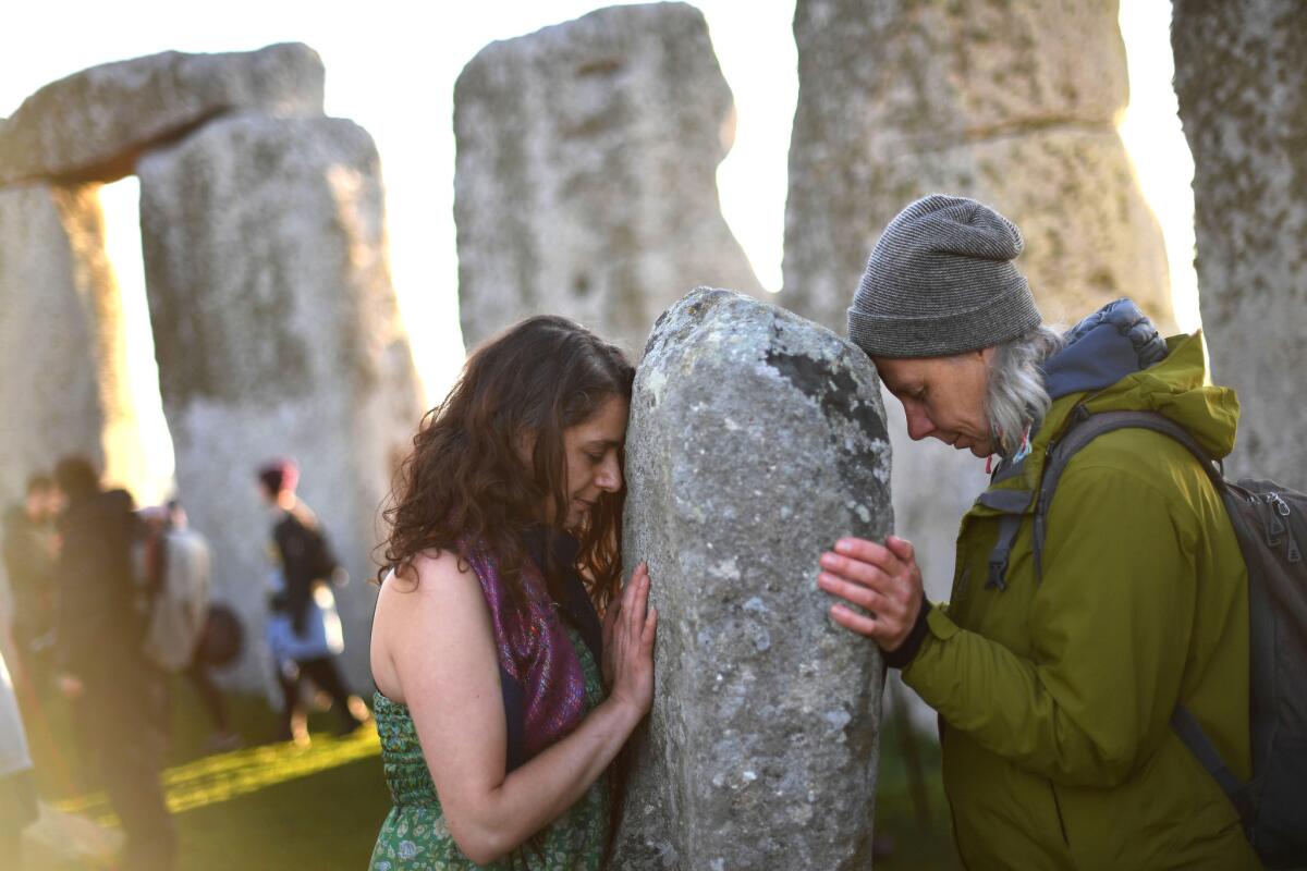 Visitors celebrate the summer solstice dawn at Stonehenge. (Finnbarr Webster / Getty Images)
