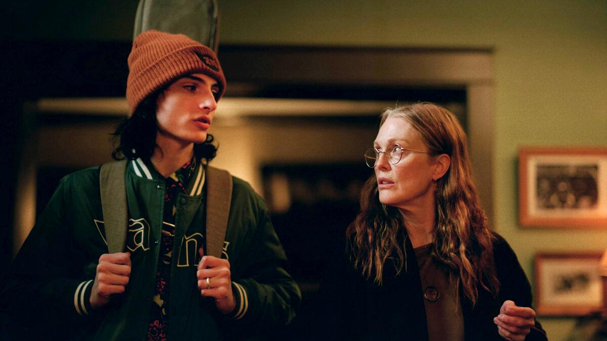 A young man in a knit cap and a woman in glasses in the movie "When You Finish Saving the World."