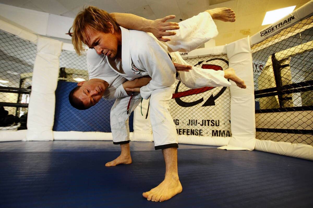 Actor Sean Patrick Flanery, standing, practices jiujitsu with Henry Akins at his gym, Dynamix.