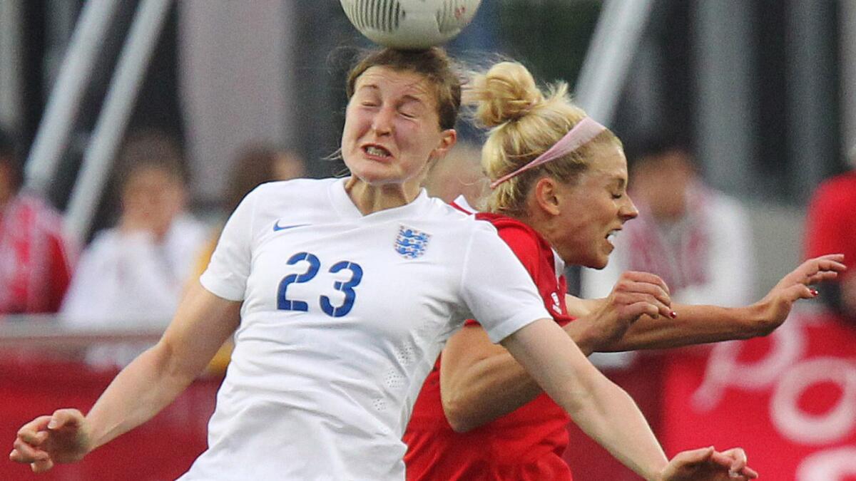 England's Ellen White, left, heads the ball in front of Canada's Lauren Sesselmann during an international friendly in Hamilton, Canada, on Friday.