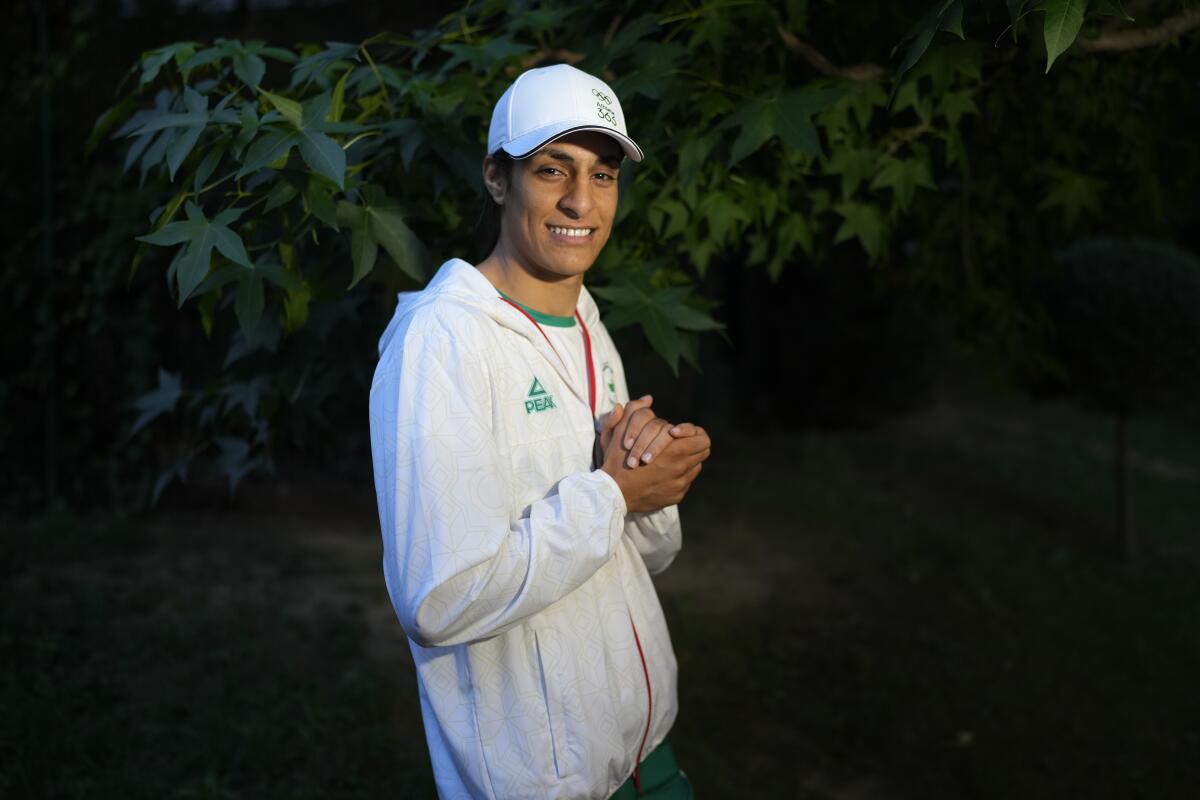 Algerian boxer Imane Khelif poses for a photo after an interview with SNTV at the 2024 Summer Olympics Sunday.