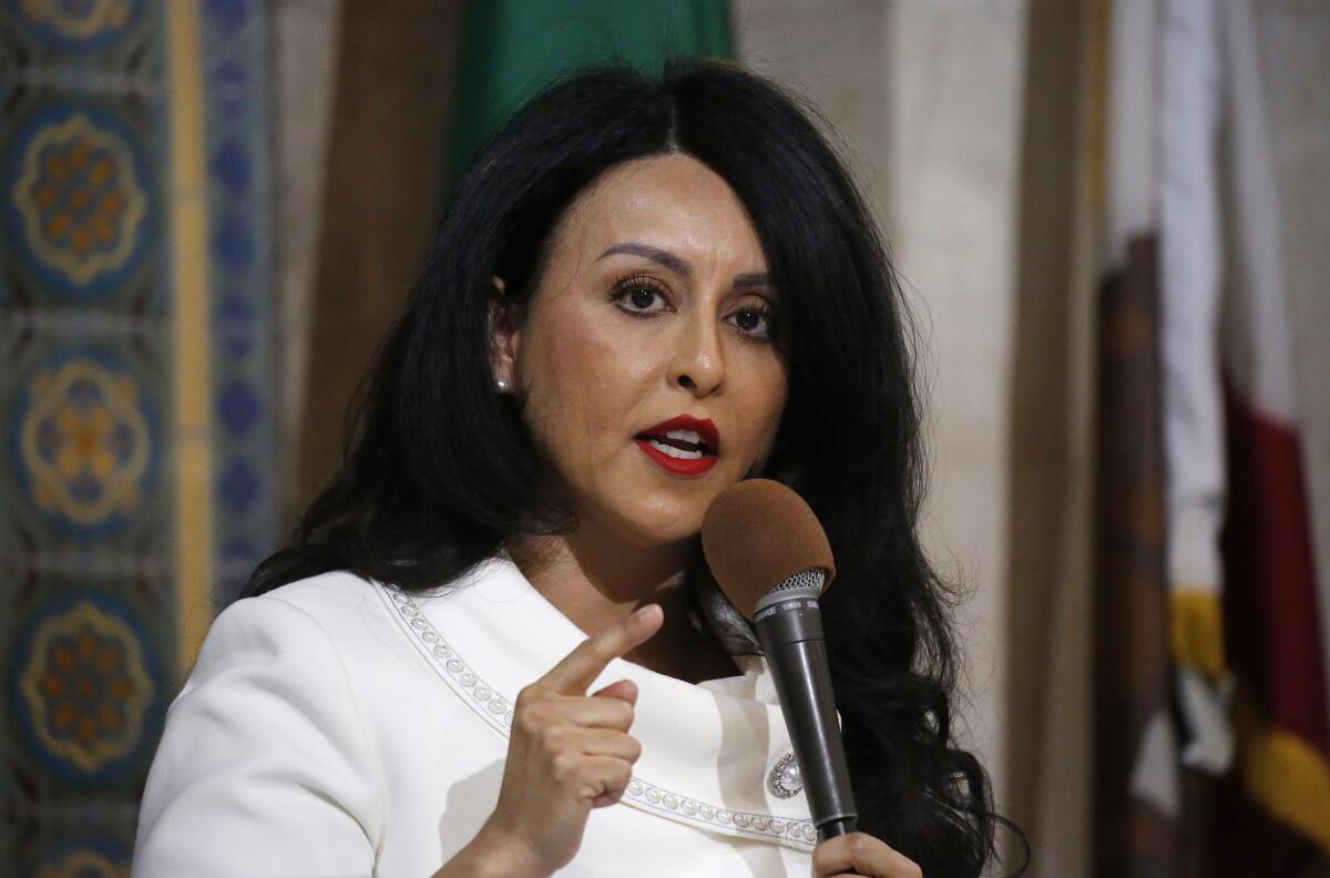 A woman stands with a mic in her hand.