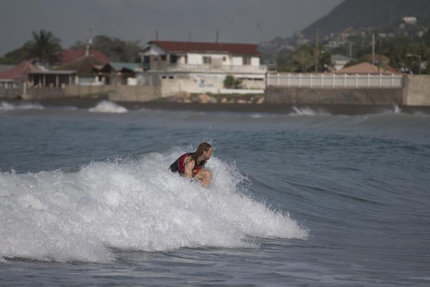A man surfs at Wickie Wackie Beach before the arrival of Hurricane Matthew in Kingston, Jamaica, on Sunday.