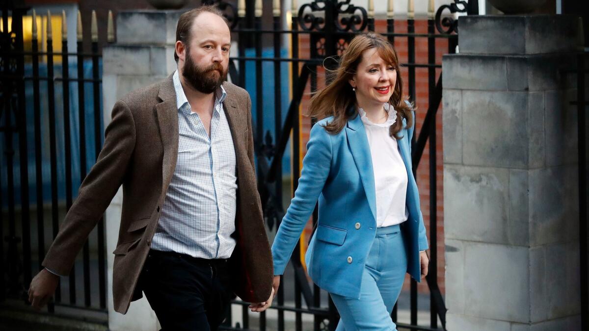 Prime Minister Theresa May's top two aides — Chiefs of Staff Nick Timothy and Fiona Hill — leave Conservative Party headquarters in London on Friday. They have both resigned in the wake of the Conservative Party's disastrous election result.