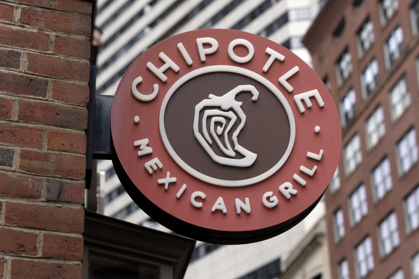 FILE - The Chipotle Mexican Grill logo is seen on a storefront, Friday, Oct. 14, 2022, in Boston. On Monday, March 27, 2023, union officials said Chipotle Mexican Grill has agreed to pay $240,000 to former employees as part of a settlement stemming from a complaint that the company violated federal law by closing a restaurant where workers wanted to unionize. (AP Photo/Michael Dwyer, File)