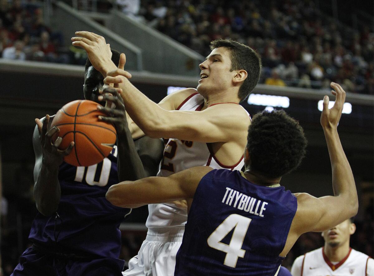 USC forward Nikola Jovanovic, center, had 28 points against Washington during the Trojans' 98-88 win over the Huskies at Galen Center on Jan. 30.