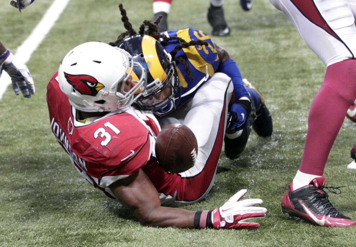 Cardinals running back David Johnson (31) fumbles as he's hit by Rams safety/linebacker Mark Barron during the third quarter of a game on Dec. 6.