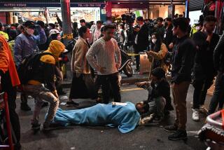 EDITORS NOTE: Graphic content / A man receives medical attention, after dozens of people suffered cardiac arrest during Halloween celebrations, in the popular nightlife district of Itaewon in Seoul on October 30, 2022. - Nearly 60 have died from a Halloween crush in Seoul, a fire department official said on October 30. (Photo by Anthony WALLACE / AFP) (Photo by ANTHONY WALLACE/AFP via Getty Images)