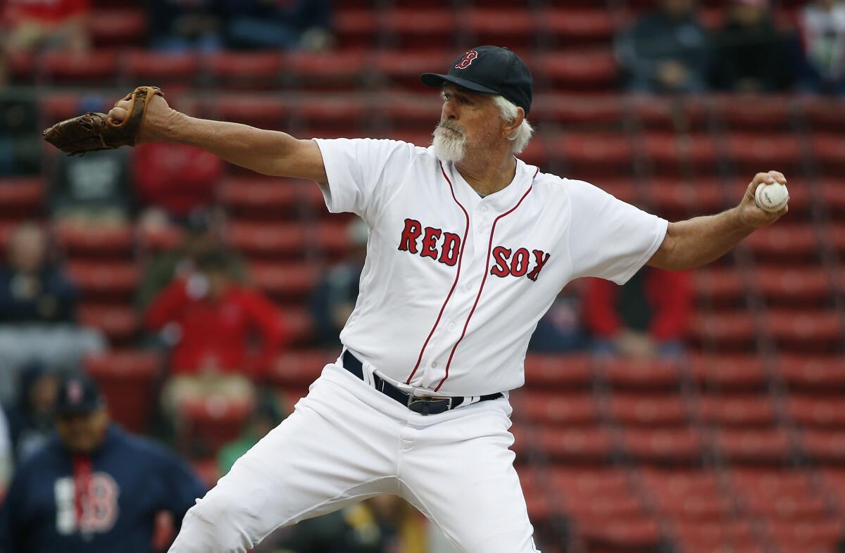 FILE - Former Boston Red Sox's Bill Lee pitches during a Red Sox alumni baseball game on May 27, 2018, in Boston. Lee had stopped breathing after collapsing in the bullpen during an exhibition game on Friday, Aug 19, 2022, but paramedics and two shocks with a defibrillator helped resuscitate the 75-year-old pitcher, according to a witness at the scene. (AP Photo/Michael Dwyer, File)