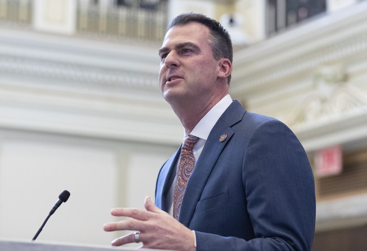 FILE - Oklahoma Gov. Kevin Stitt delivers his State of the State address in Oklahoma City on Monday, Feb. 7, 2022. A national civil rights group is suing Gov. Stitt over his decision to prohibit the state from issuing birth certificates listing a nonbinary option. Lambda Legal filed the lawsuit, Monday, March 14, 2022, in federal district court in Tulsa. (AP Photo/Alonzo Adams File)