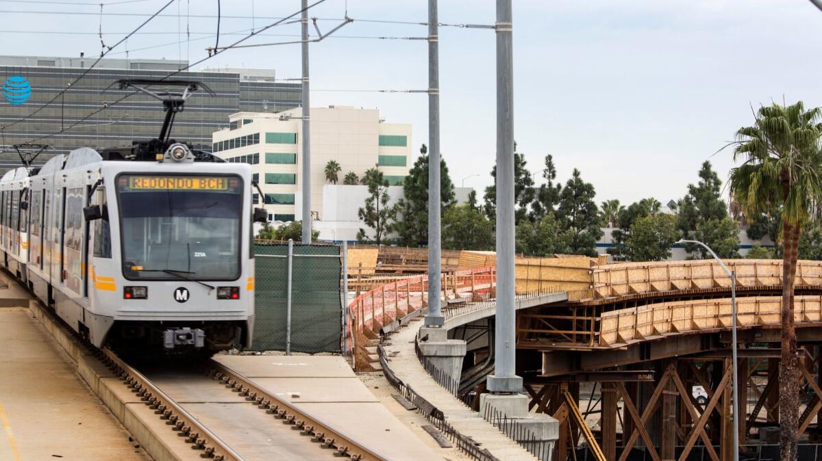 A Metro Green Line train passes by a transit line under construction in El Segundo in this 2016 file photo. 
