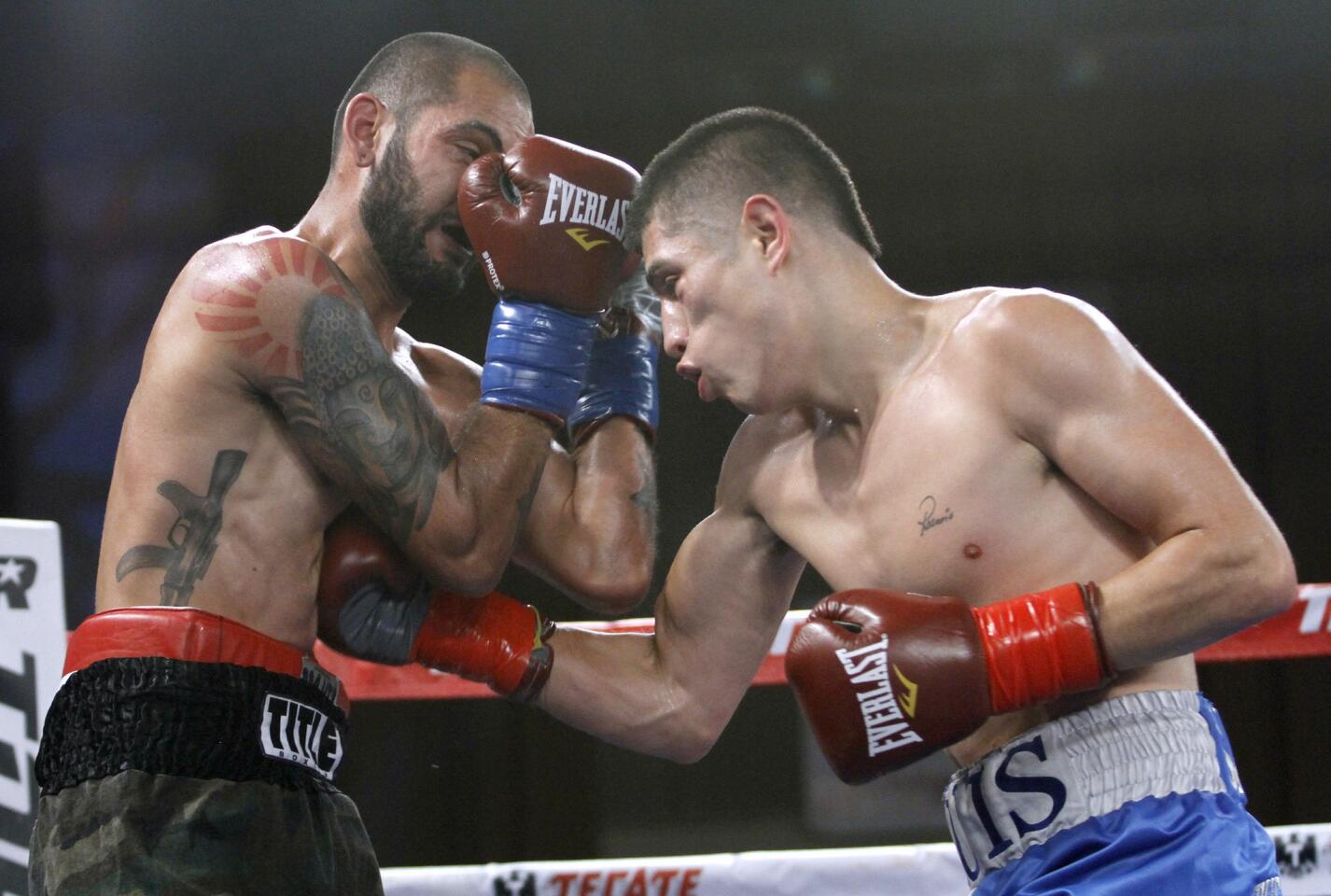 Eventual winner Luis Sedano of Duarte, right, lands a blow to the body of Luis Diaz of Mexico, left, in the lightweight fight of Art of Boxing, Bash Boxing and Top Rank event at the Glendale Civic Auditorium on Saturday, Aug. 9, 2014.