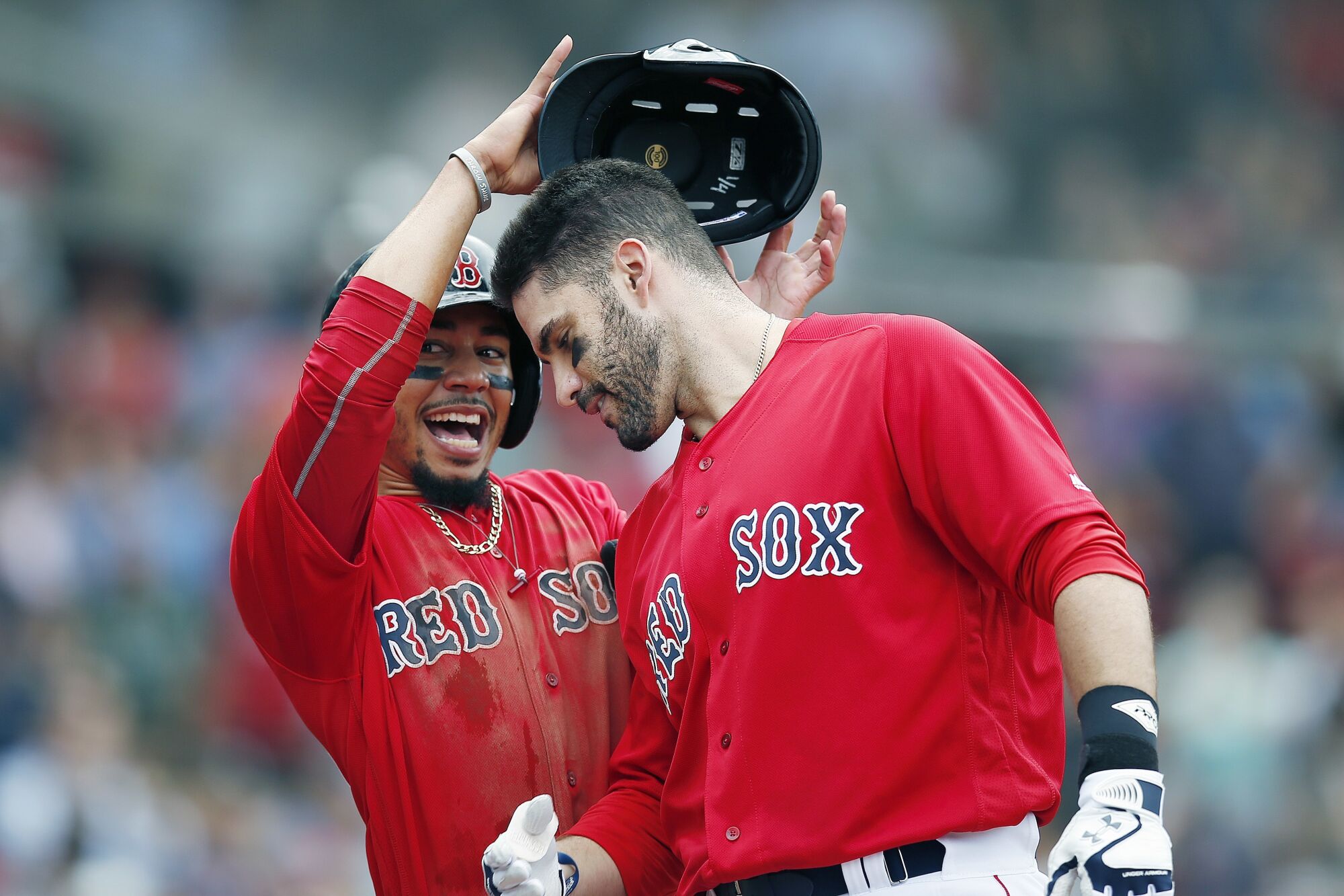 Boston Red Sox's Mookie Betts, left, celebrates a home run by J.D. Martinez against the Baltimore Orioles on Sept. 26, 2018.