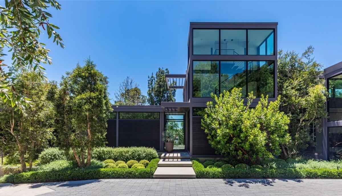 A metal and wood home with three-story atrium.