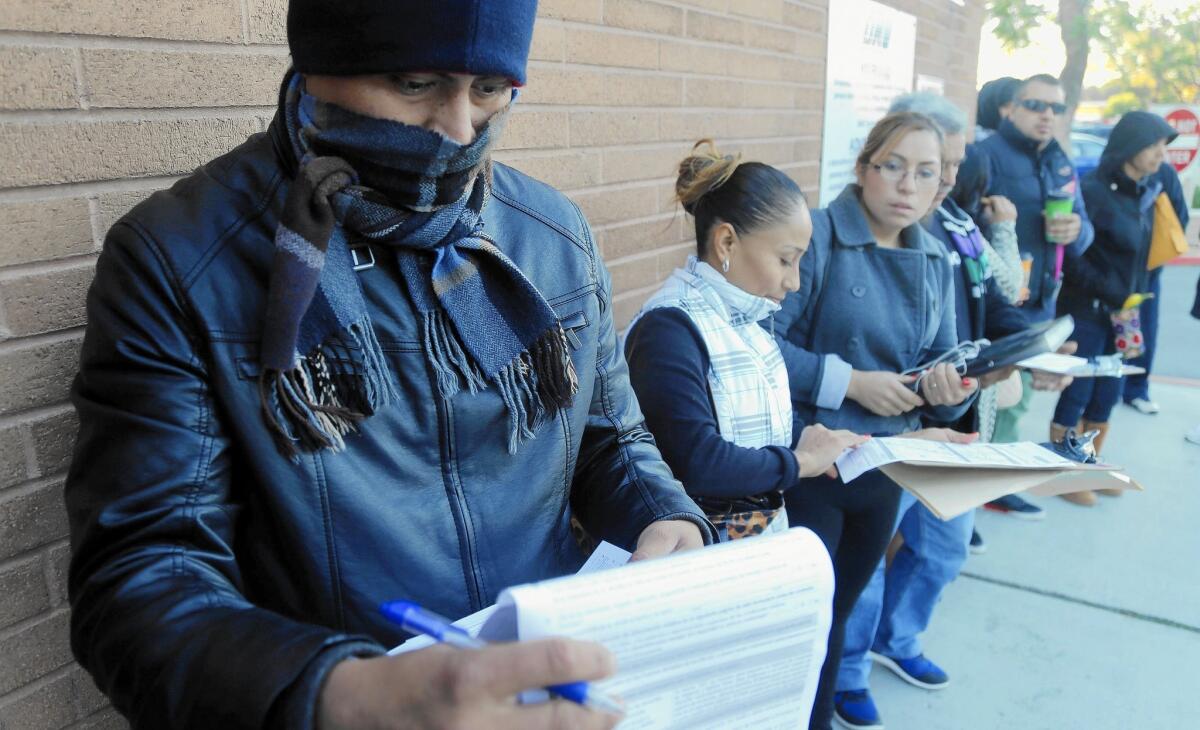 Antonio Aguirre waits in line at the Santa Ana DMV office as the state begins accepting applications for driver's licenses for people in the country illegally.