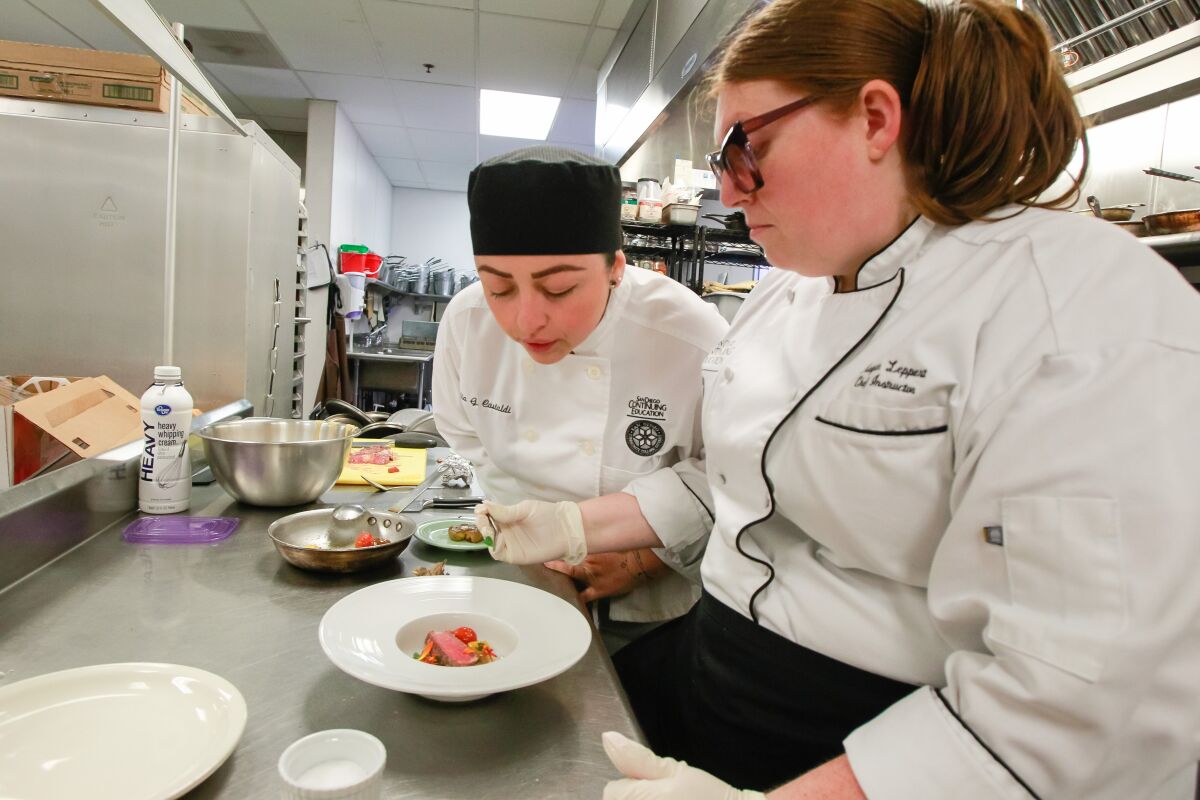 Chef instructor Megan Leppert (right) works with Nidia Castaldi in the Continuing Education culinary arts program.