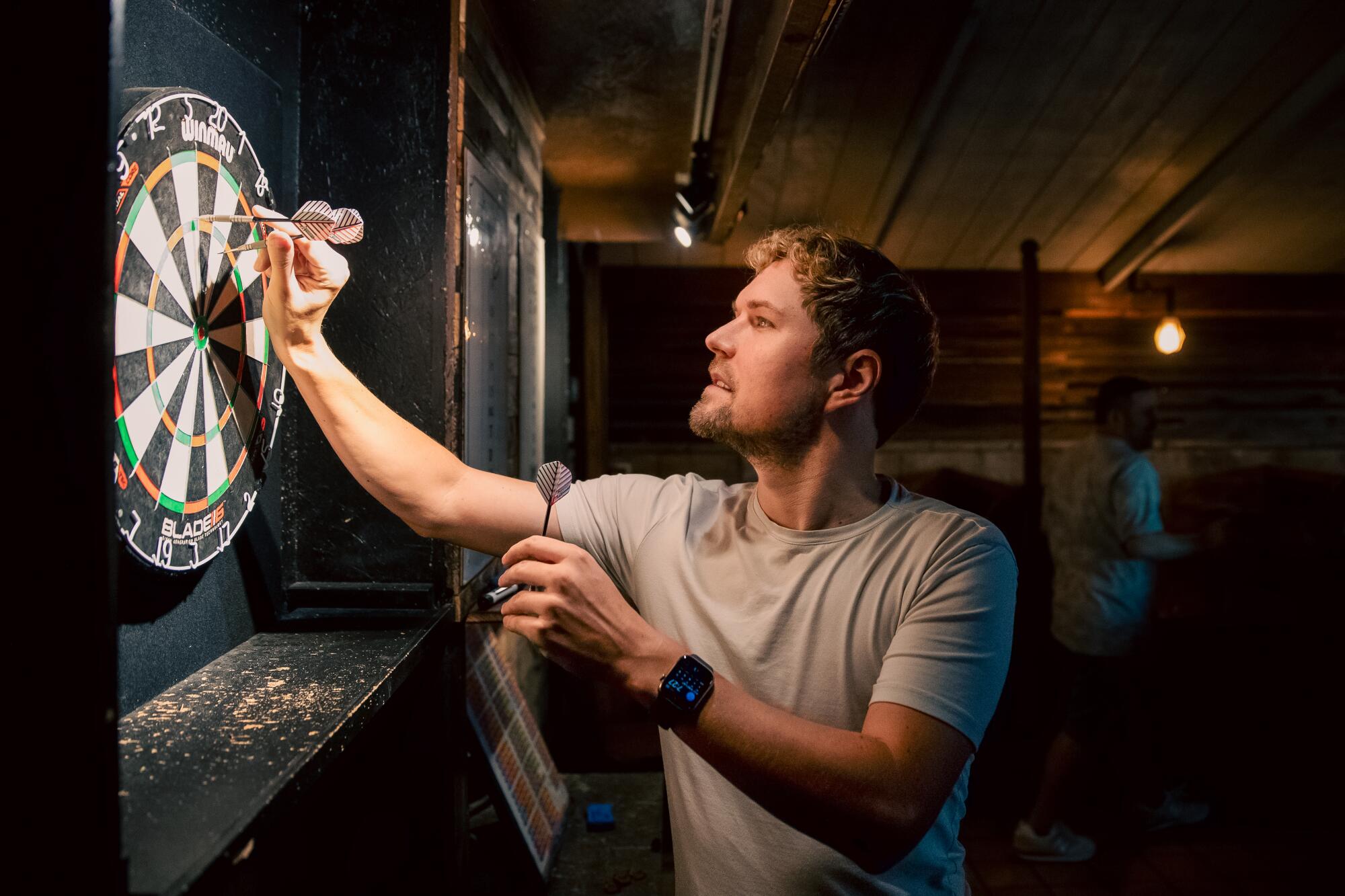 Eric Ligocki plays darts at Residuals Tavern in Studio City. The production assistant is on path to joining the DGA.