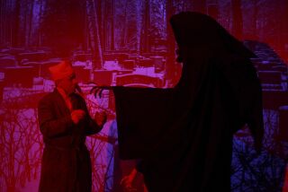 Ebenezer Scrooge, played by John Culver meets Ghost of Christmas Yet to Come during a dress rehearsal of the Julian Theater Company's "A Christmas Carol" at Julian High School on Thursday, December 12, 2019 in Julian, California.