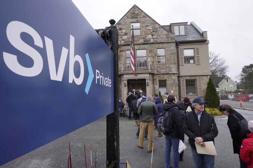 FILE - Customers and bystanders form a line outside a Silicon Valley Bank branch location, Monday, March 13, 2023, in Wellesley, Mass. SVB Financial Group is filing for Chapter 11 bankruptcy protection, Friday, March 17. SVB Financial Group is no longer affiliated with Silicon Valley Bank or the bank’s private banking and wealth management business, SVB Private. SVB Financial Group ran Silicon Valley Bank up until it was seized last Friday.(AP Photo/Steven Senne, File)