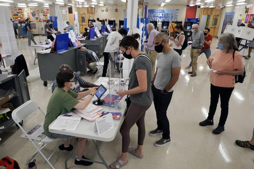 FILE - Voters sign in at Frank McCourt High School for New York's party primaries, June 22, 2021, in New York. New York City, long a beacon for immigrants, is on the cusp of becoming the largest place in the U.S. to give noncitizens the right to vote. Legally documented, voting-age noncitizens, who comprise nearly one in 10 of the city's 8.8 million inhabitants, would be allowed to cast votes in elections to pick the mayor, City Council members and other municipal officeholders under a bill nearing approval. (AP Photo/Richard Drew, File)