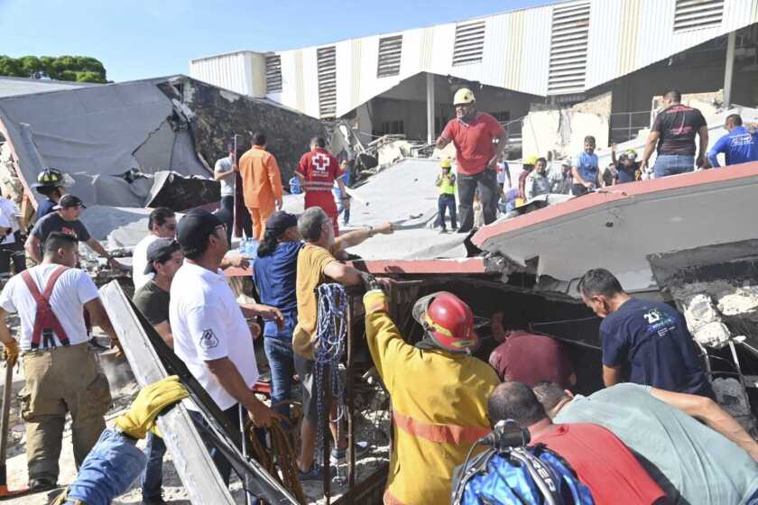 Rescue workers search for survivors amid debris after the roof of a church collapsed during a Sunday Mass in Ciudad Madero, Mexico, Sunday, Oct. 1, 2023. The Bishop of the Roman Catholic Diocese of Tampico said the roof caved in while parishioners were receiving communion. (Alejando de Angel/El Sol de Tampico via AP)