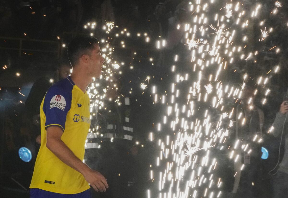 Cristiano Ronaldo walks during his official unveiling as a new member of Al Nassr soccer club in in Riyadh, Saudi Arabia, Tuesday, Jan. 3, 2023. Ronaldo, who has won five Ballon d'Ors awards for the best soccer player in the world and five Champions League titles, will play outside of Europe for the first time in his storied career. (AP Photo/Amr Nabil)