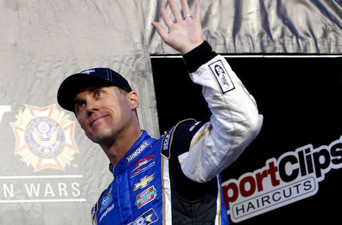 NASCAR driver Kevin Harvick waves to the crowd before the Nationwide Series race on Friday night at Darlington Raceway.