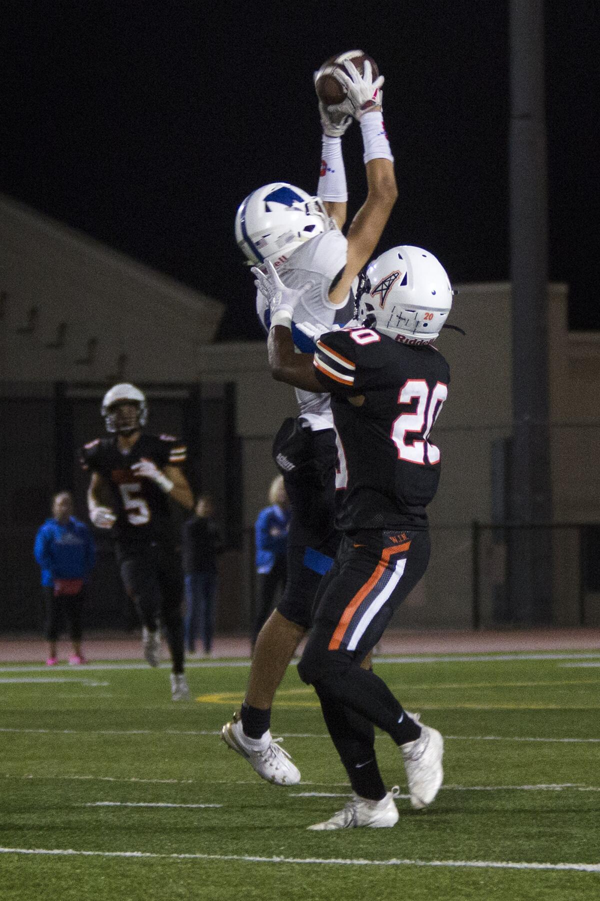 Western's Anthony Barbosa intercepts a pass intended for Huntington Beach's Hideo Ray in a nonleague game at Cap Sheue Field on Friday.