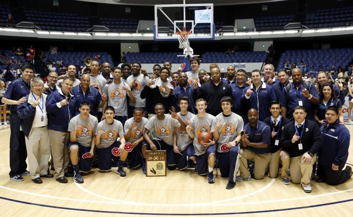 The St. John Bosco basketball team poses with the trophy after winning the CIF Division 3A high school basketball finals on March 2.