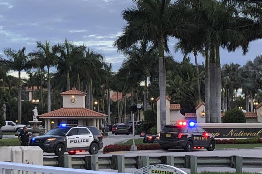 Police respond to The Trump National Doral resort after reports of a shooting inside the resort Friday, May 18, 2018 in Doral, Fla. A man shouting about Donald Trump entered the president's south Florida golf course early Friday, draped a flag over a lobby counter and exchanged fire with police before being arrested, police said. One officer received an unspecified injury, officials said. (AP Photo/Frieda Frisaro)