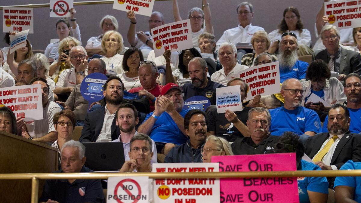 Detractors and supporters of the Poseidon desalination water facility voice their opinion during the California State Lands Commission meeting at Huntington Beach City Hall on Oct. 19.