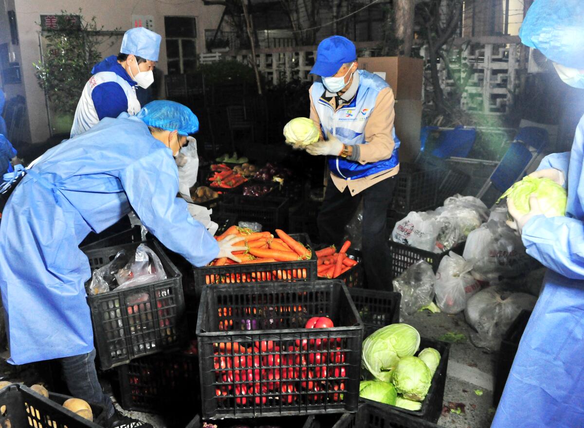 People with crates of vegetables