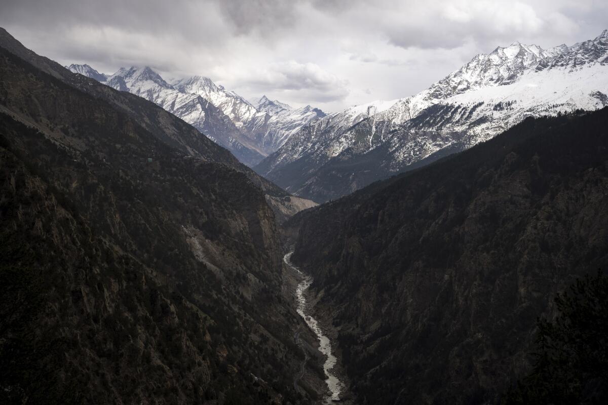 The Sutlej River in a valley below the  Himalayan range.